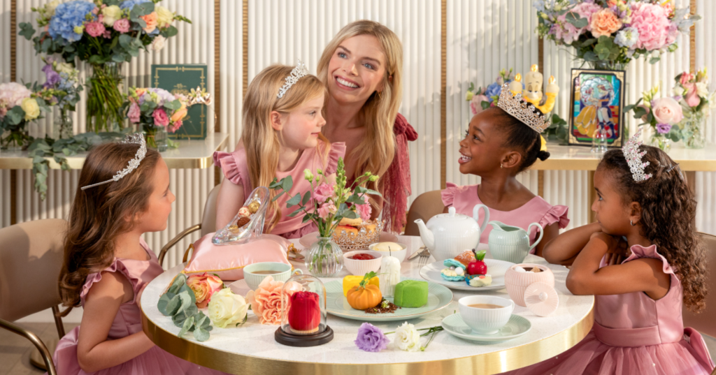 A small group of children sitting around a decorated table at an intimate birthday celebration